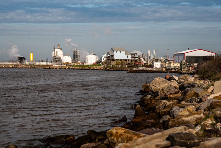 Oil and gas company infrastructure sits on the edge of the Brazos river.